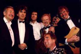 Concert photo: Brian May live at the Grosvenor House Hotel, London, UK (Water Rats Ball with Phil Collins, Dec Cluskey, Joe Brown, Lonnie Donnegan, George Harrison and Bert Weedon) [November 1992]